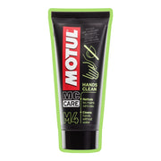 Motul M4 Hands Clean 100ml hand cleaner with orange gel, designed for removing grease and dirt.